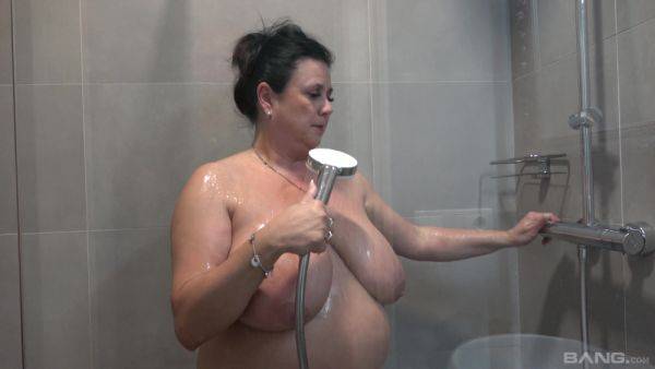 Busty nude mature showers and masturbates in a kinky combo on pornoboobs.com
